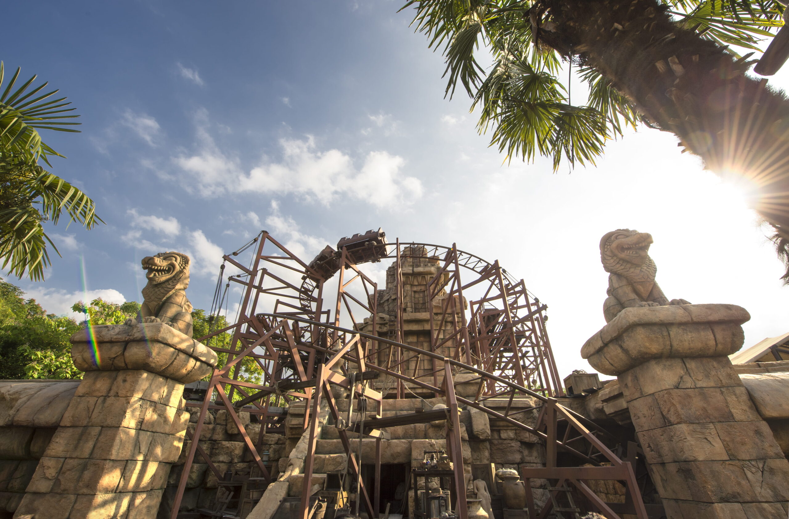 Indiana Jones and the Temple of Peril attraction at Disneyland Paris, surrounded by ancient stone ruins and serpent statues.