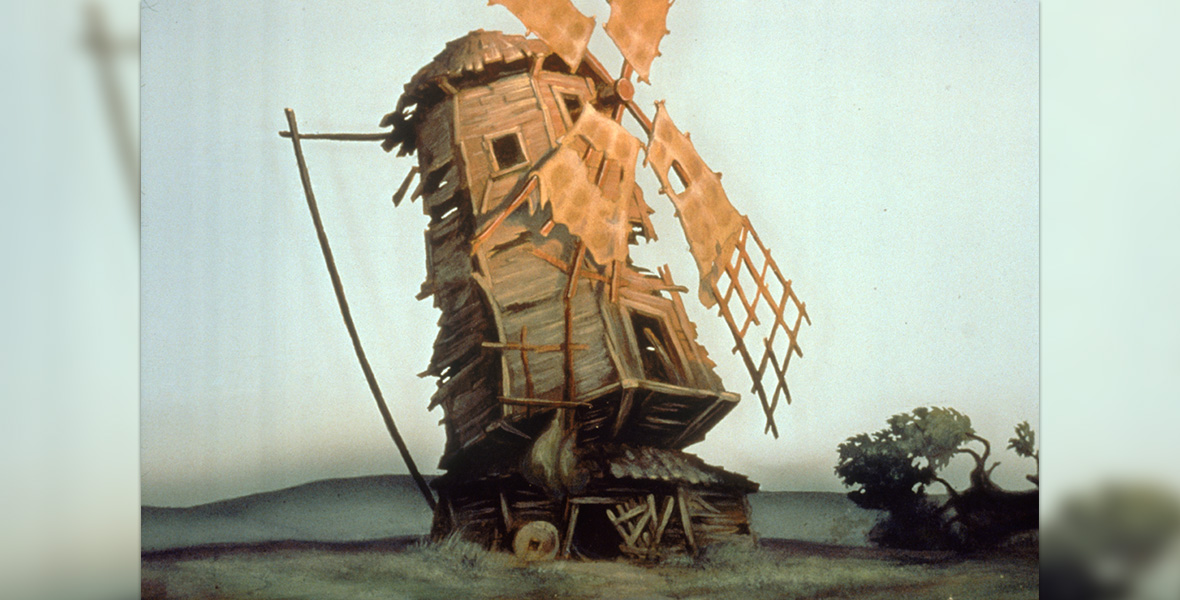 Image tirée du court métrage d'animation Disney Le Vieux Moulin, montrant un vieux moulin en bois délabré, aux ailes endommagées, dans un paysage rural.